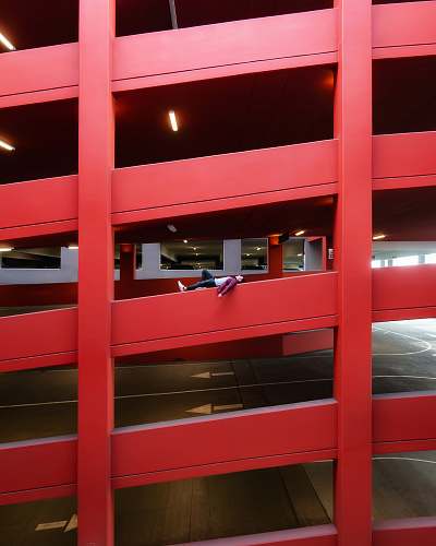 furniture person lying on railing of parking lot building building